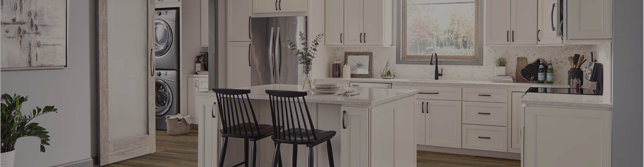 White cabinetry in a kitchen with wood-look flooring